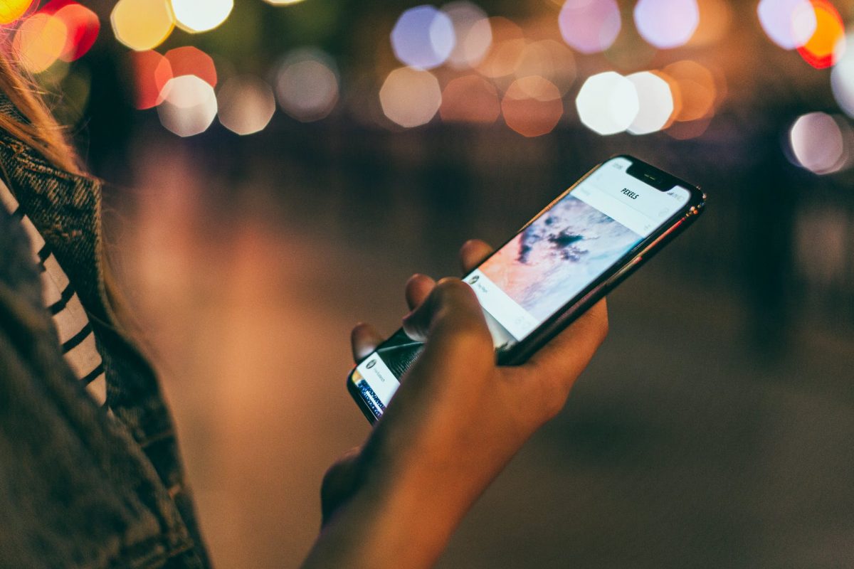 person holding space gray iphone x