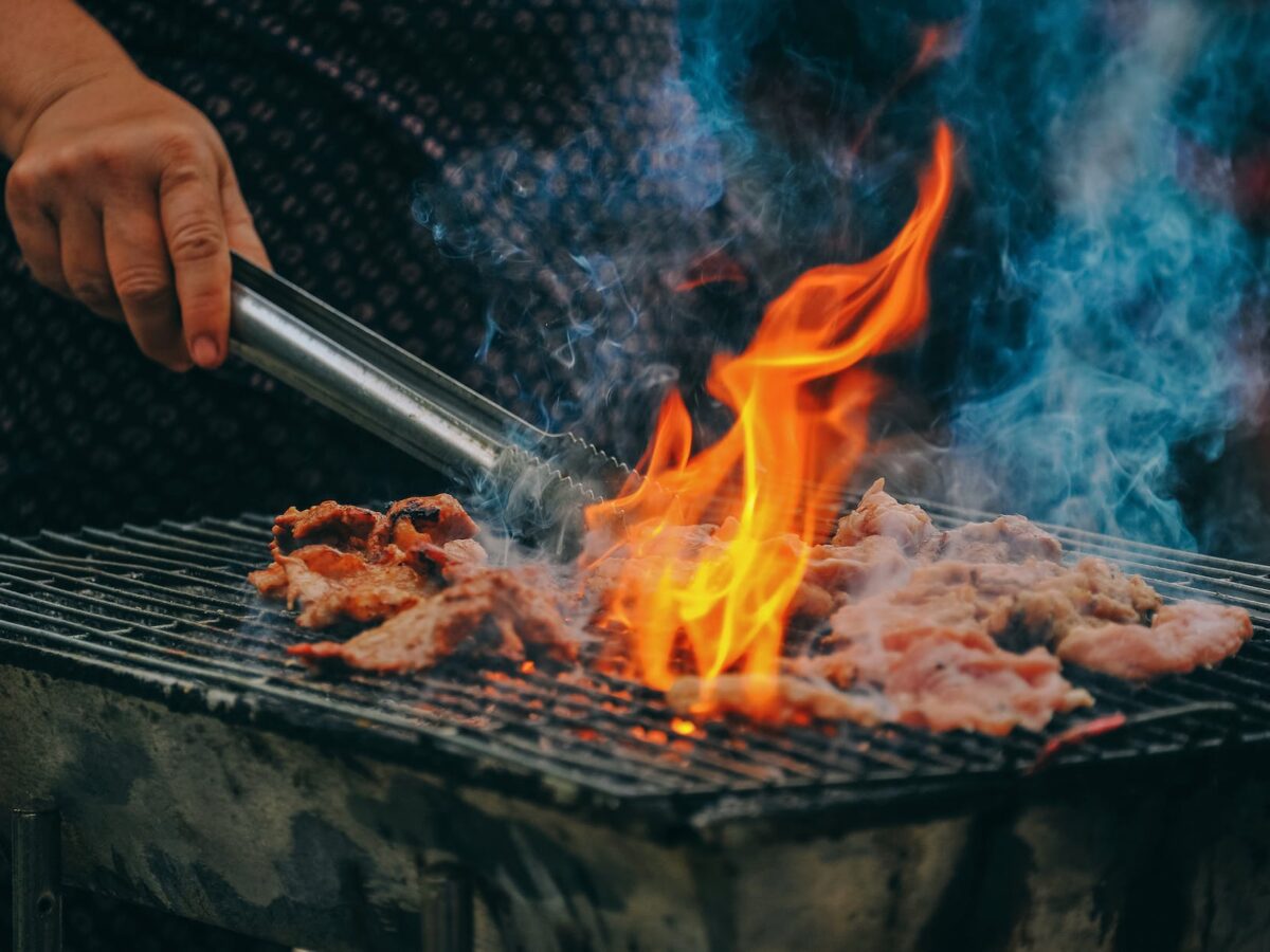 close up photo of man cooking meat